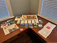 Entire lot laid out on desk showing various guides, magazines, poster, pairing sheets
