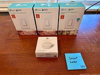 Front view showing three TP-Link Kasa Smart light switch boxes and one Google Nest temperature sensor box