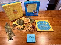 Full kit showing box front and back, booklet, die-cut pieces and strips
