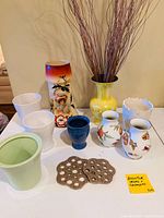 Full lot showing all vases, pots, cachepot and pot trivets on table