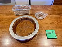 Pie plate with attached metal shield, covered butter dish, citrus reamer