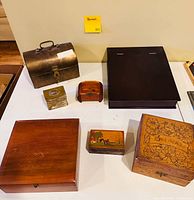 All seven boxes closed, showing size and material variety