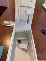 Interior view of box showing instruction sheet, keys and mounting hardware inside