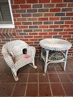 table and chair upright against brick wall showing overall form and paint wear