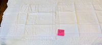 Pair of white pillow shams laid flat showing full size and matching design