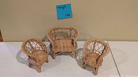 Front view of three-piece wicker doll furniture set: loveseat centered, two armchairs flanking