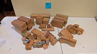 Collection of wood blocks, alphabet cubes and wood car arranged on table