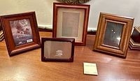 Front view of four wooden picture frames on tabletop