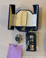 Watch head, presentation box opened, sealed plastic hangtag visible
