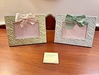 Front view of both zebra stripe photo frames displaying colors, patterns and bows