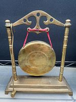 Small brass tabletop gong on stand with striker