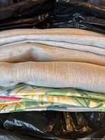Curtain panels and placemats folded together in storage bag
