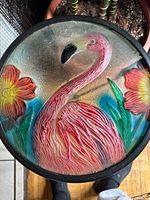 Close-up of glass top showing flamingo and flower design