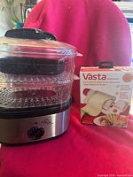 Vasta sheet slicer box next to two-tier electric food steamer