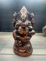 Front view of cast brass Ganesha figurine