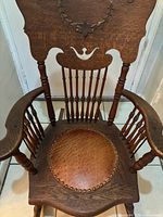 Top angled view highlighting carved backrest and arms