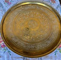 Full view of round engraved brass tray