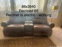 Front view of brown bonded leather power reclining loveseat showing overall appearance and dimensions overlay