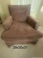 Front view of brown fabric armchair showing removable seat and loose back cushion