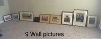 All nine of the pictures leaned against wall for group overview
