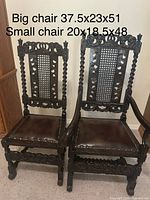 Front view both chairs showing size difference, carved details, caned backs, leather seats