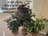 All three artificial plants grouped together in planters
