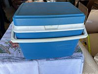 Cooler exterior showing blue body, white rim and handle