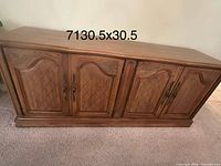 Front view of oak credenza showing four doors and overall style