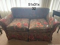 Front view of loveseat showing overall style, fabric pattern, two seat cushions and dimensions overlay