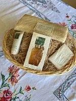Overall view of basket with perfume, lotion, soap and loofah inside