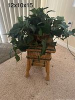 Full view of wicker side table with artificial plant on top