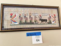 Front close view of framed papyrus artwork showing full Egyptian scene and frame detail