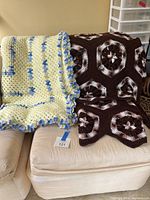 Both afghans displayed on sofa