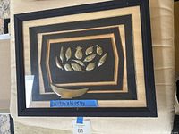 Front view showing entire framed artwork with metal relief elements and mats