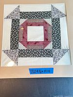Front view of quilt square showing pattern, colors, and size tape
