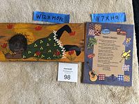 Both plaques with measuring tapes for scale