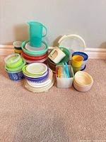 entire assortment stacked showing variety of containers, lids, cups and pitcher