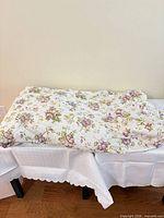 Folded floral comforter on table, showing pattern and colors