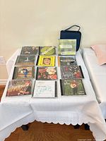 Full set of CDs and storage wallet displayed on table