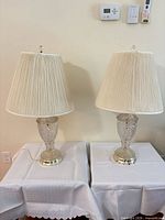 Front view of both matching table lamps with shades displayed on tables