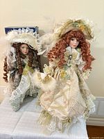 Both porcelain dolls standing on table