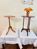 Both pedestal tables side by side for size, style and colour comparison