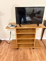 TV on stand with remote and paperwork visible