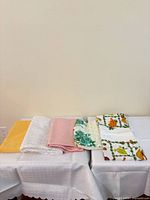 All five folded tablecloths displayed on table