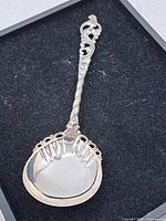 Full view of 8-inch ornate 830 silver serving spoon