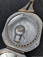 Compass open showing dial, sighting arm and scale
