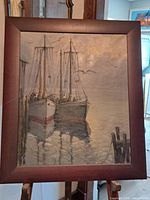 Full view of framed painting showing boats and dock