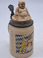 Front view showing Buddha finial lid and Bavarian graphic