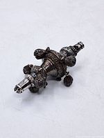 Overall view of silver hookah finial showing shape and decorative drops