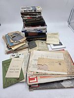 Overview of entire lot showing stacks of books and piles of loose publications